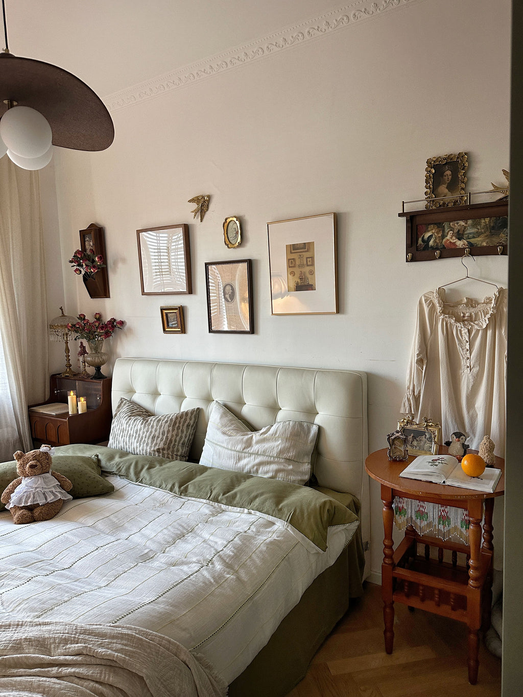 Bedroom with a bed, side table, and wall decorations