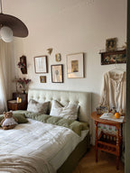 Bedroom with a bed, side table, and wall decorations